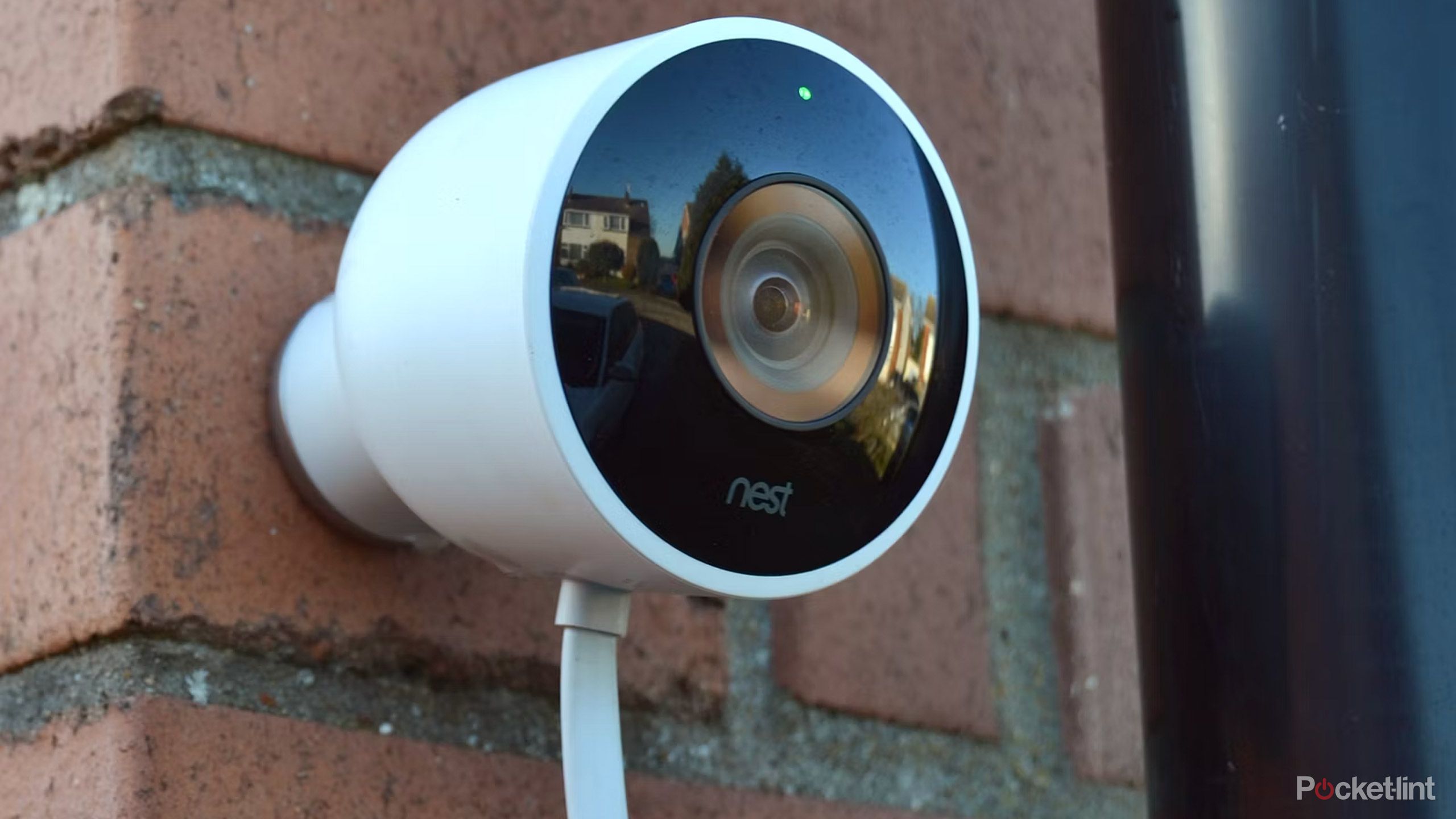 A Nest Cam mounted to brick wall