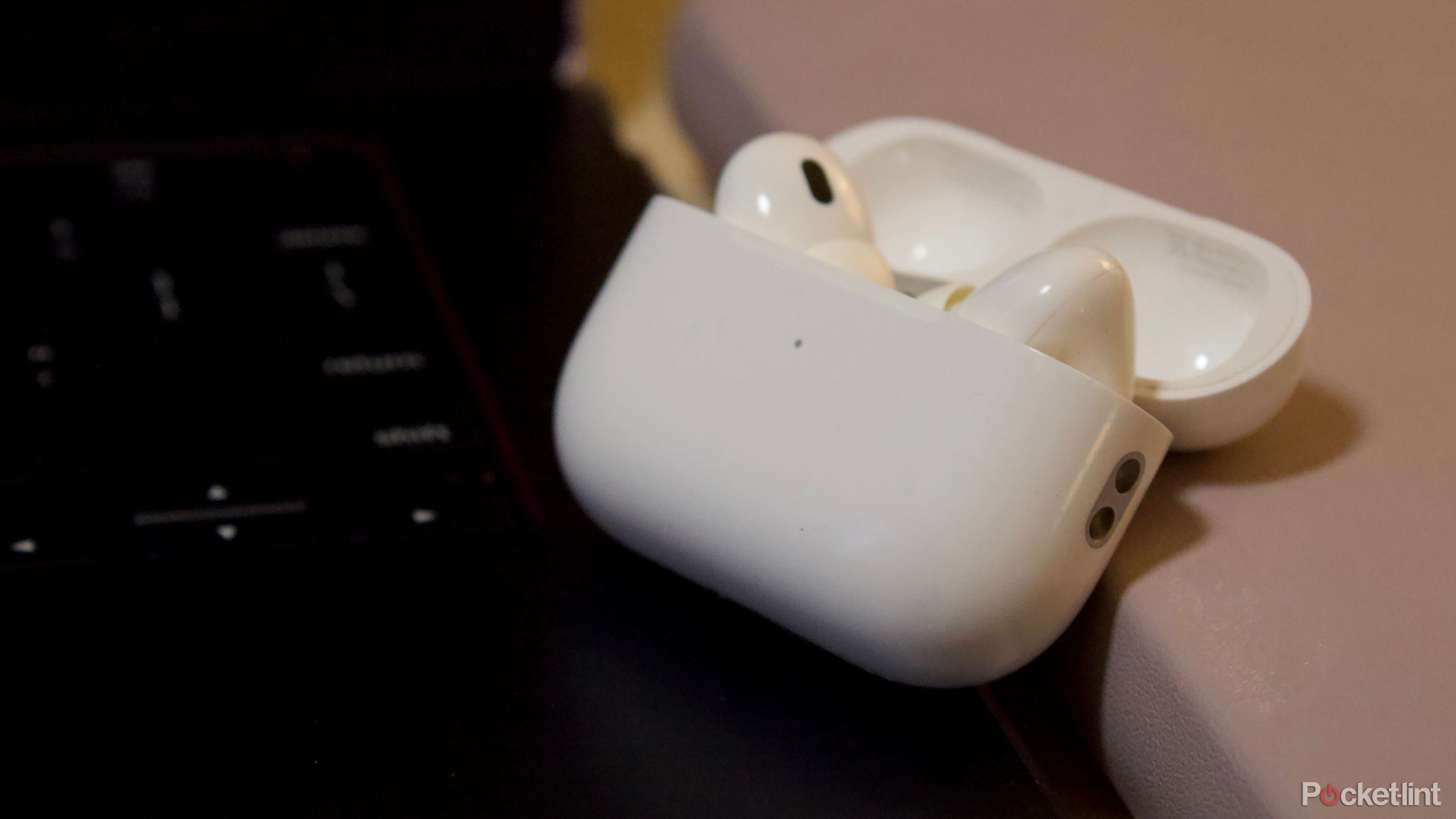 AirPods next to laptop