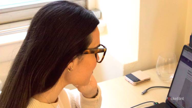 Young woman with dark hair working and wearing  3rd-Gen Amazon Echo Frames