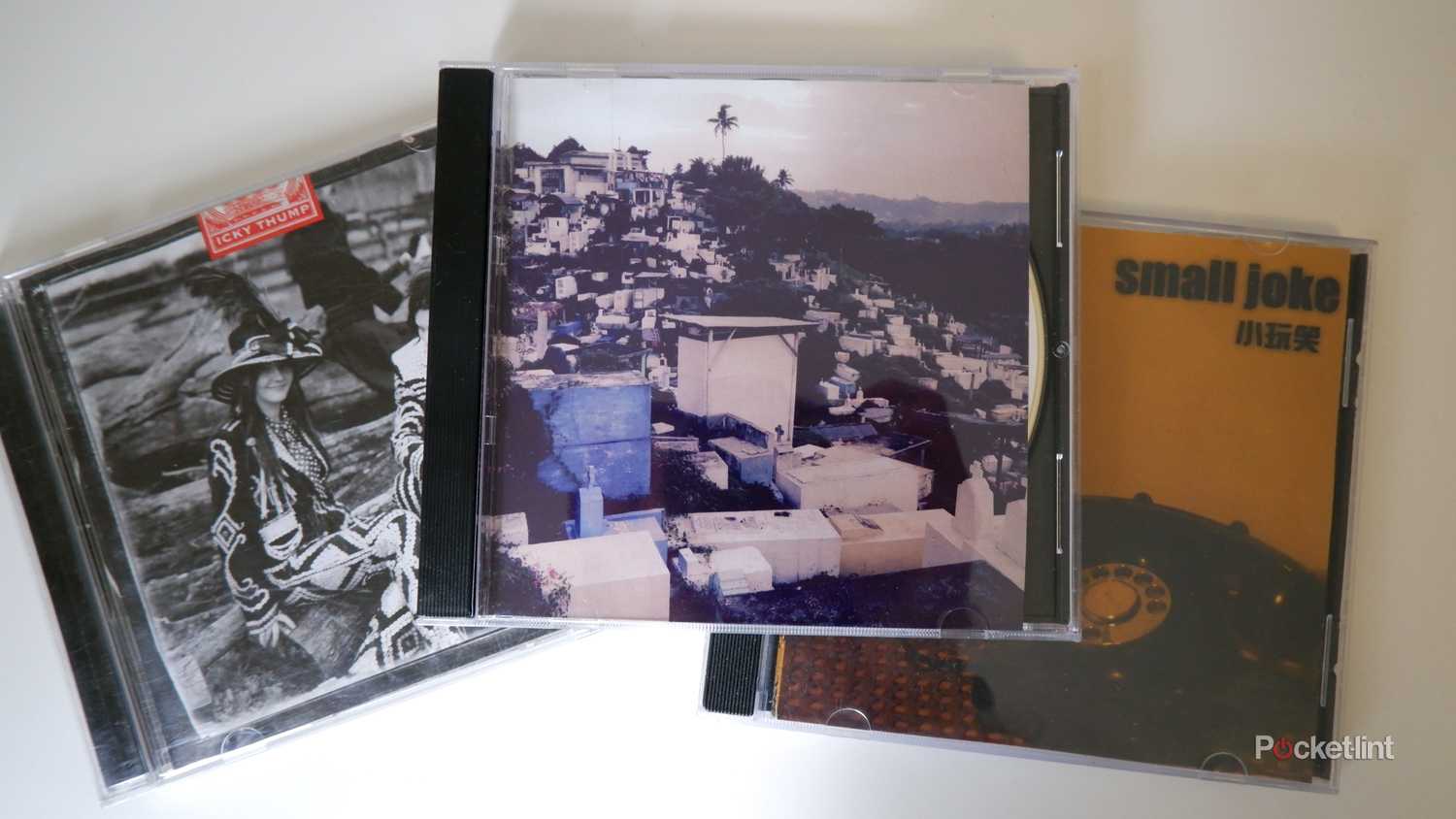 Three CDs laid out on a white surface.