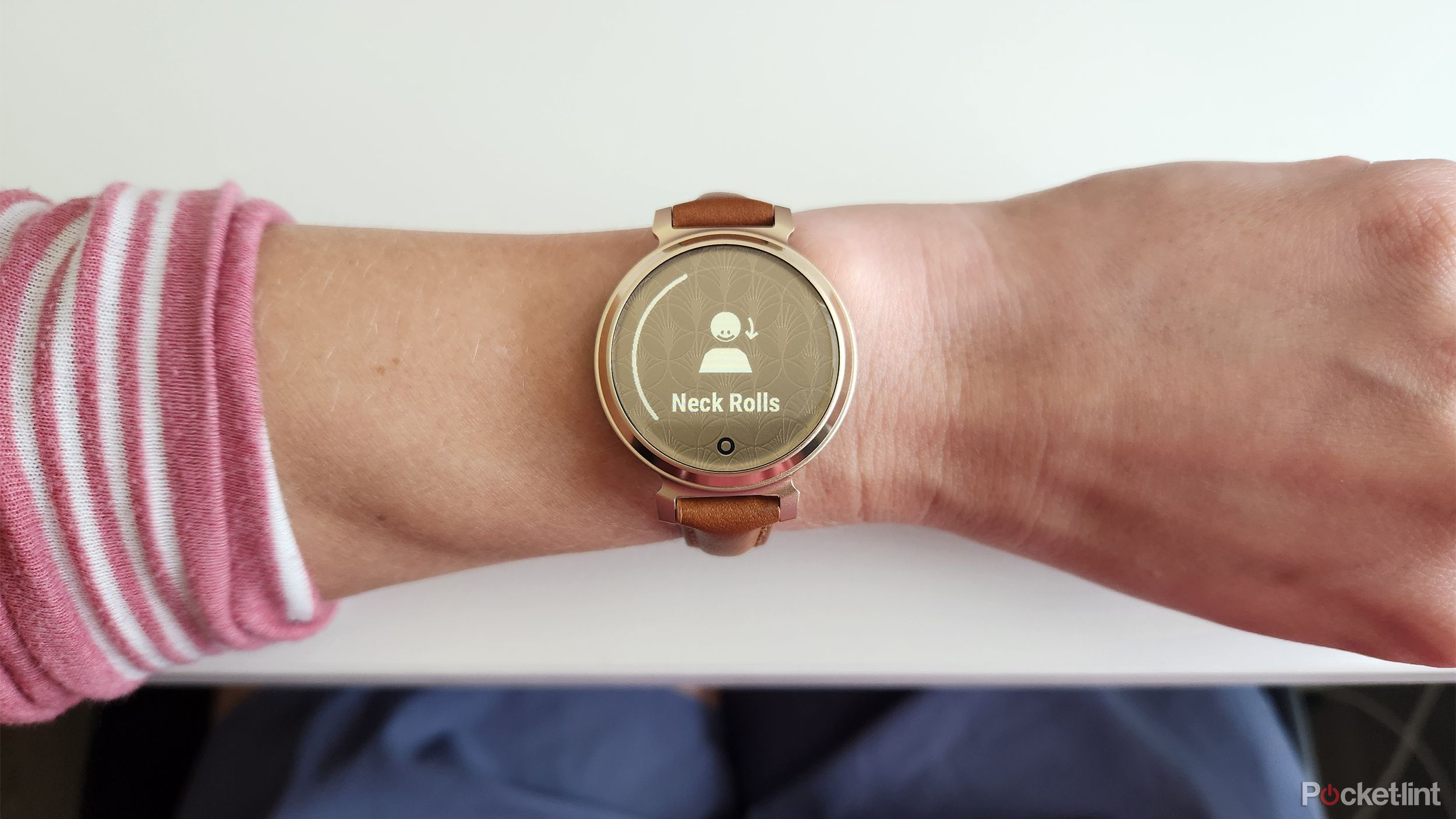 The Garmin Lily 2 smartwatch on a wrist, prompting an activity. 