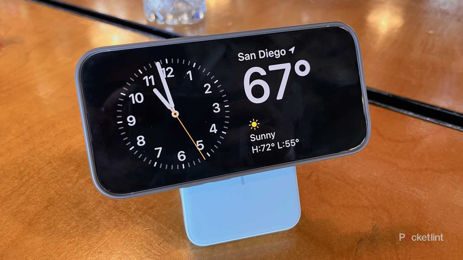An iPhone displaying StandBy mode on an iPhone 15 attached to the Anker Magnetic Battery.