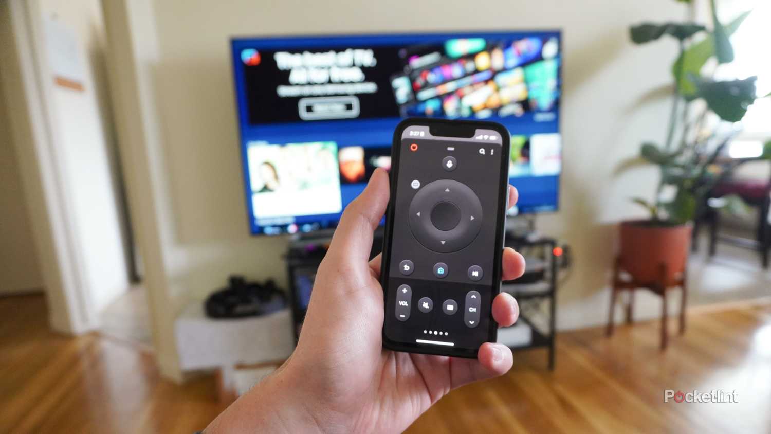 Holding the SmartThings app in front of a Samsung TV.