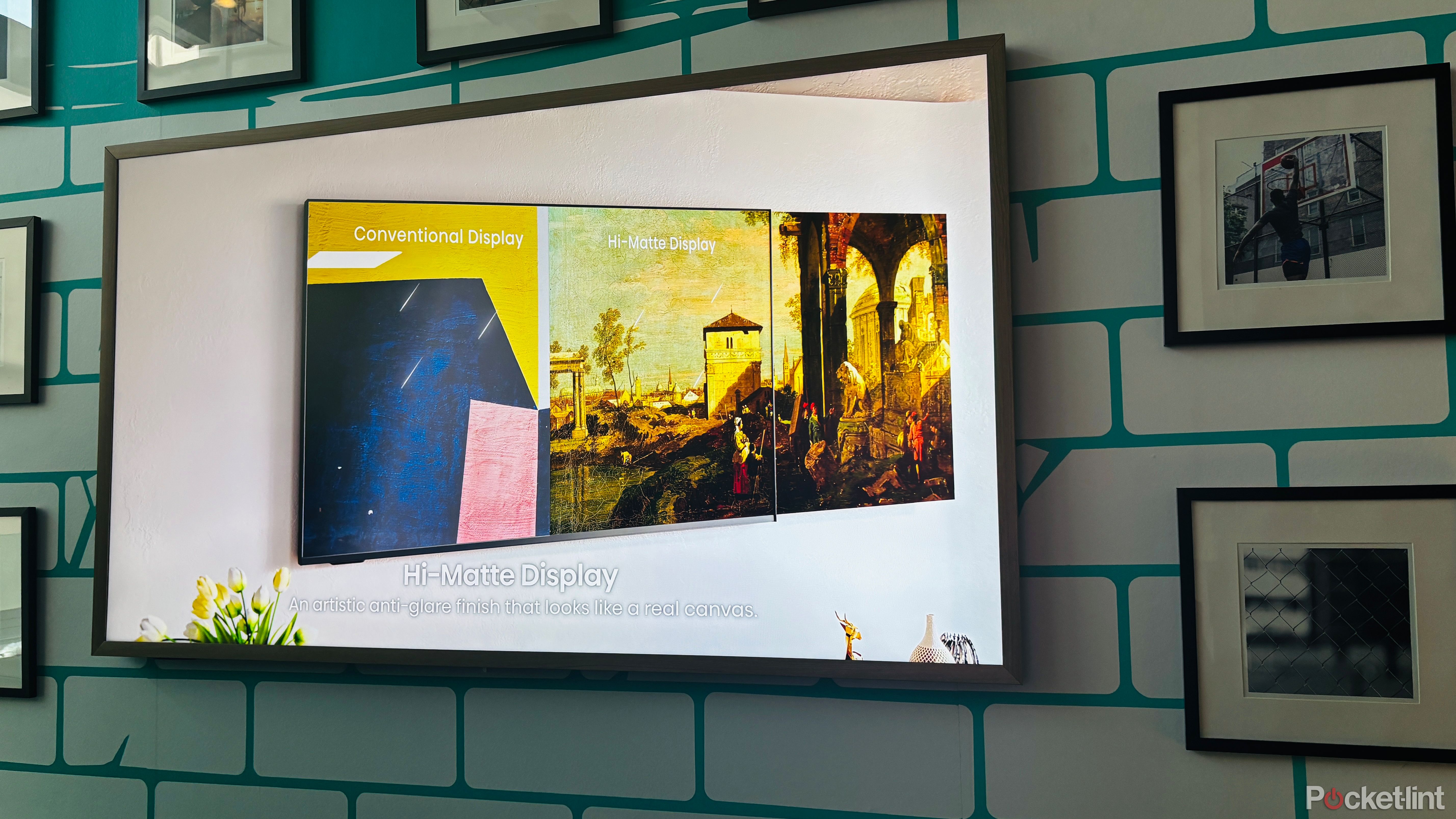 A Hisense CanvasTV on a wall covered in picture frames. 