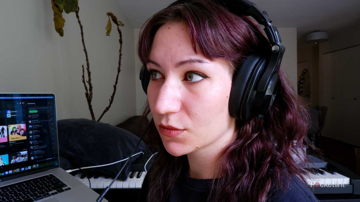 The OneOdio A70 headphones being worn, wired into a laptop