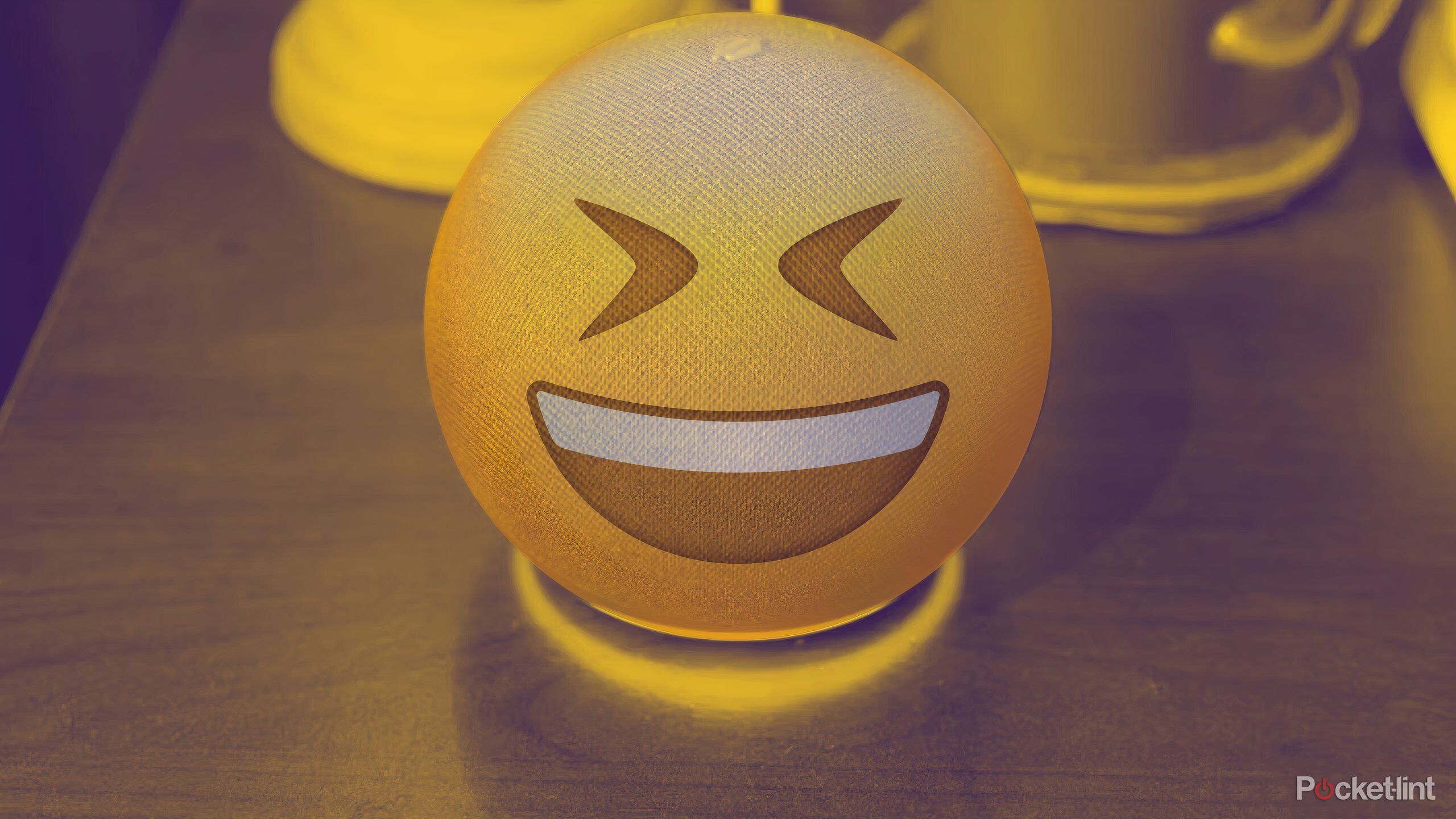 Amazon Echo with a laughing emoji superimposed over it