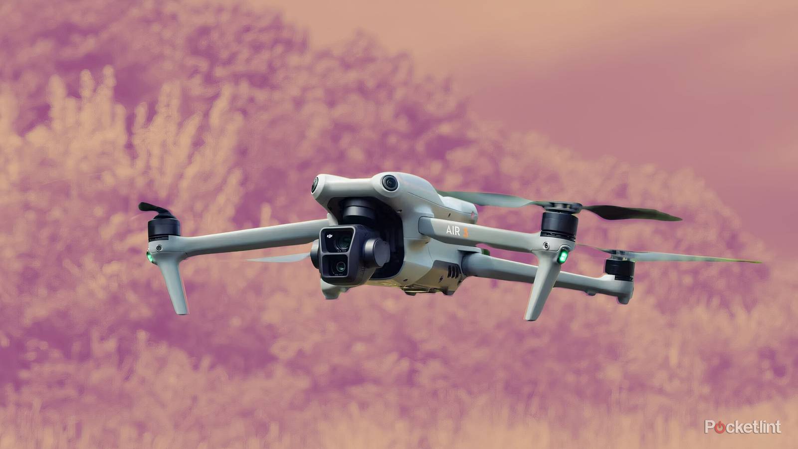 A DJI drone in front of a light orange background.