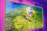 A TV with a canoe in a pond.