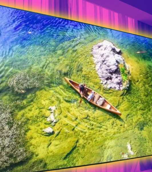 A TV with a canoe in a pond.