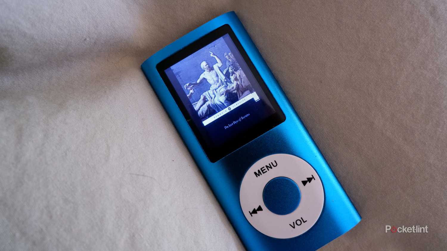 luqeeg mp3 player on a sheet showing a photo on the display