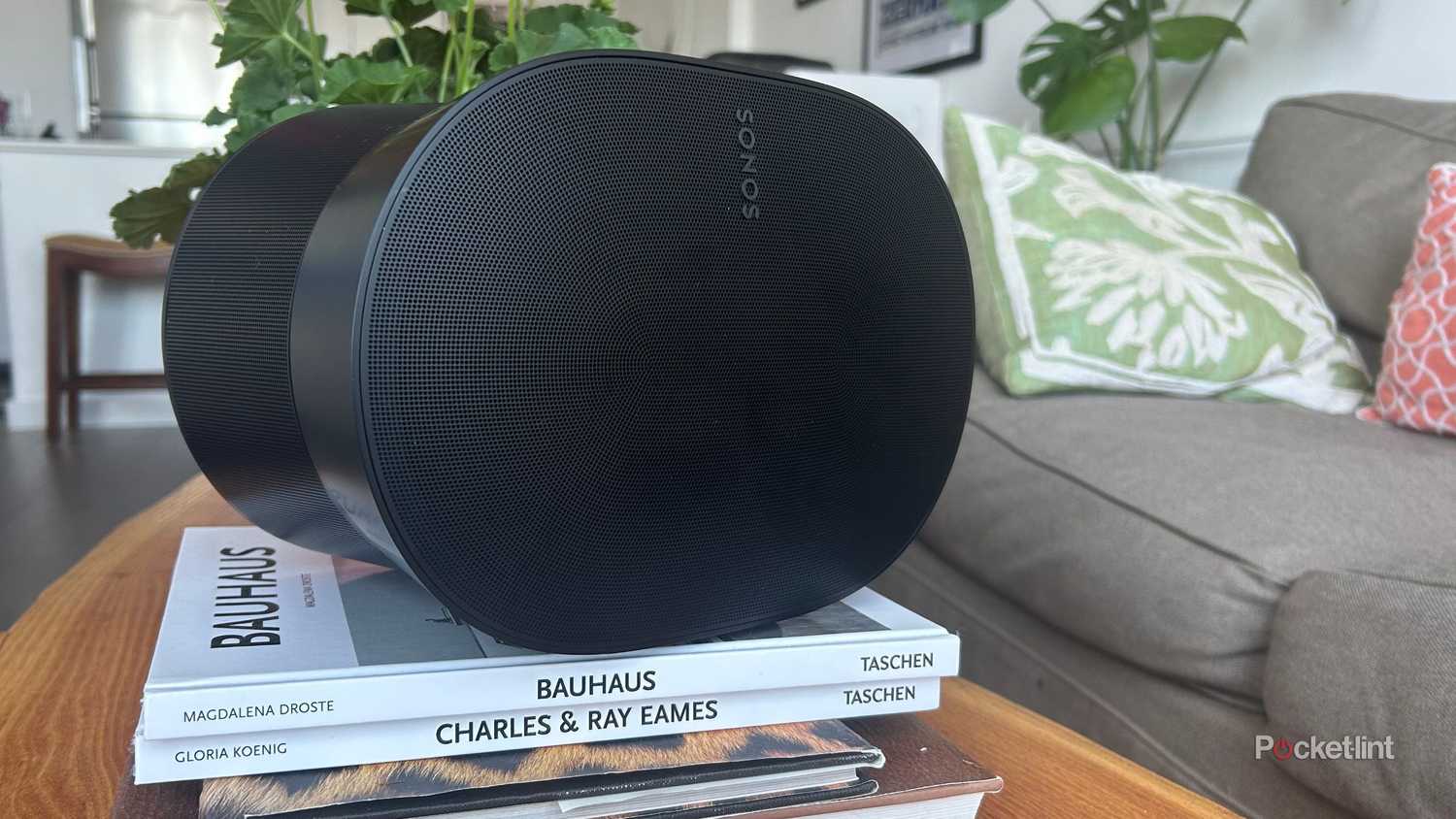 A Sonos Era 300 resting on stack of books. 