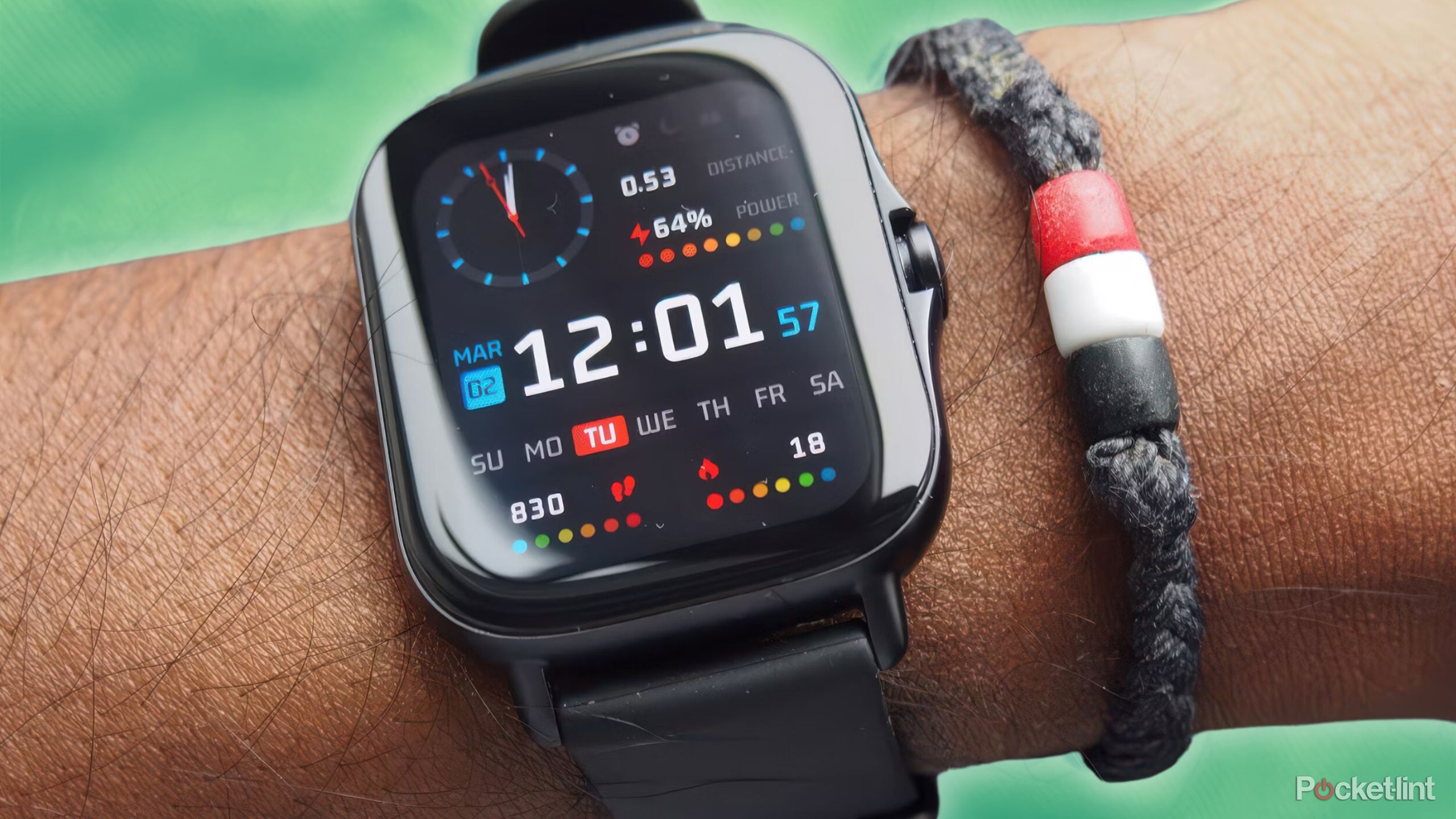 The Amazfit GTS 2e budget fitness tracker on a wrist against a green backdrop.