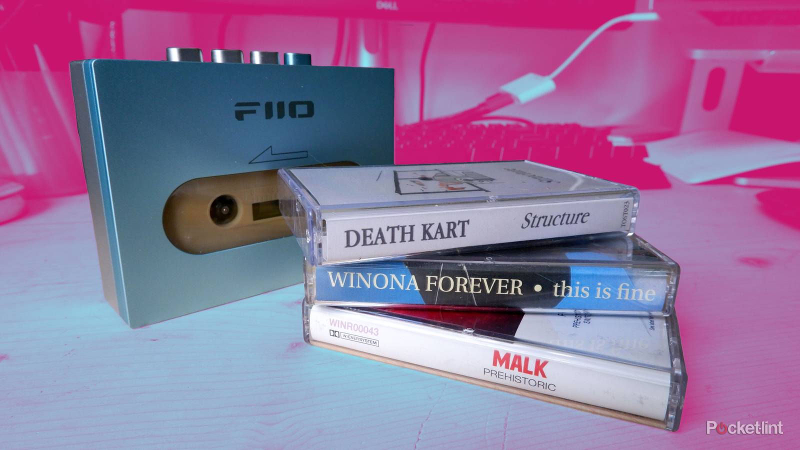 A stack of cassette tapes in front of a cassette player