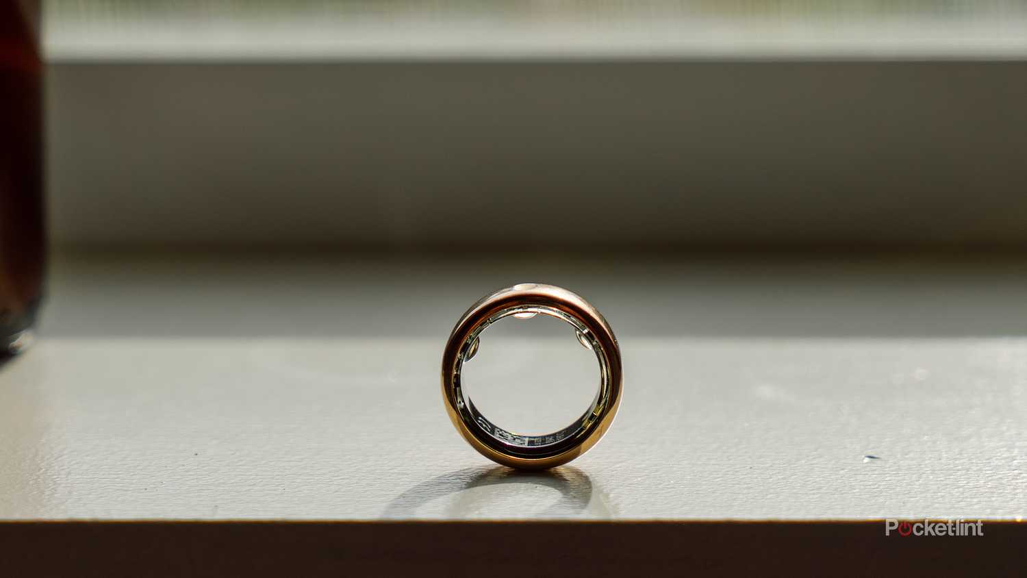 The Oura Ring 3 stands upright on a windowsill. 
