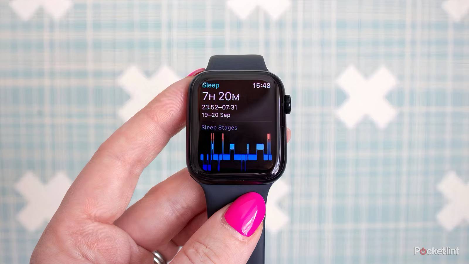 A hand holding an Apple Watch SE showing sleep tracking information.