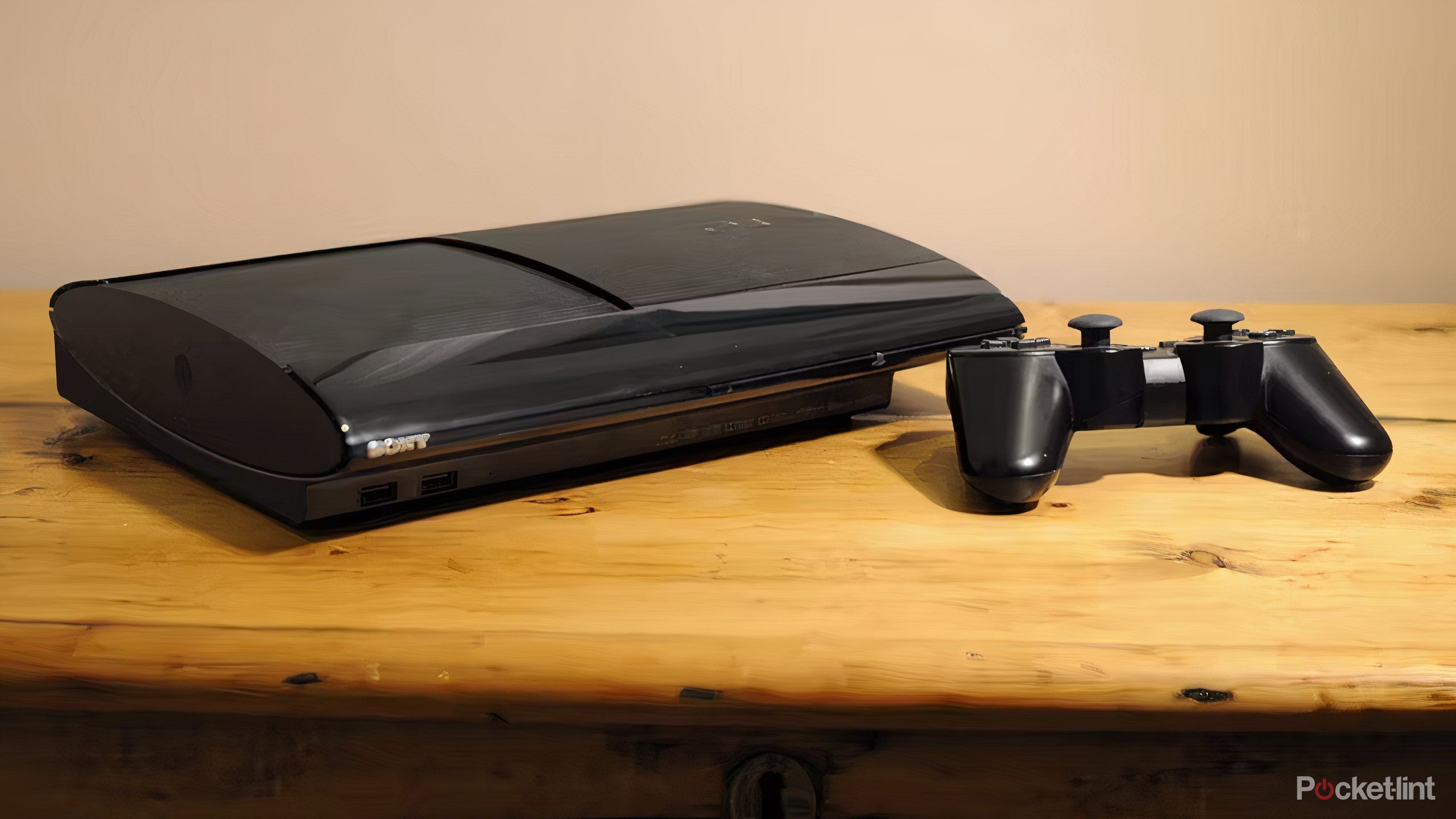 PS3 Slim on table with controller. 