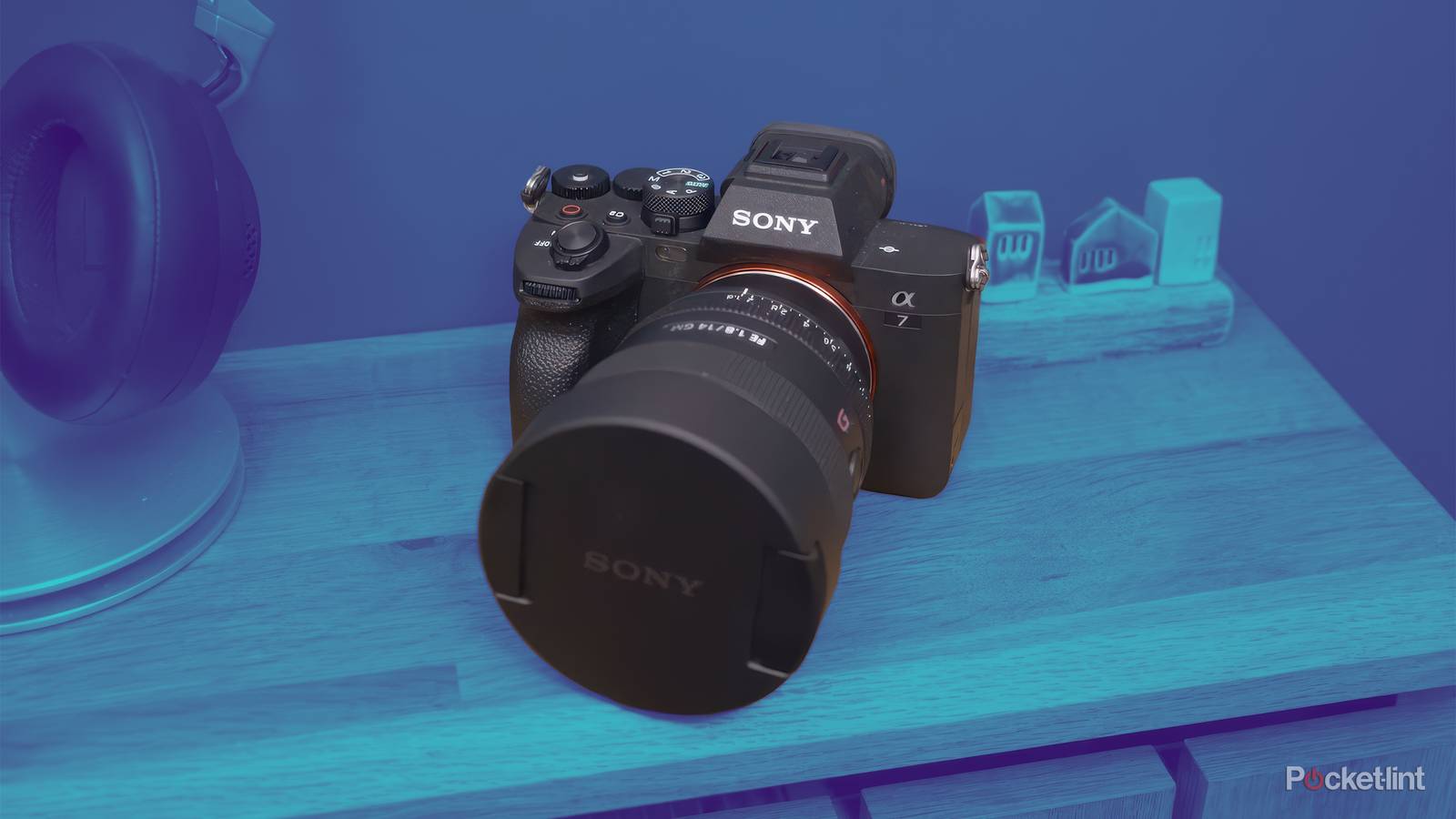 The Sony A7 IV sits on a table with the entire scene in a blue gradient. 