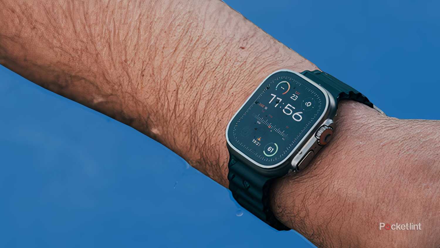 An arm wearing an Apple Watch Ultra 2 coming out of the water.