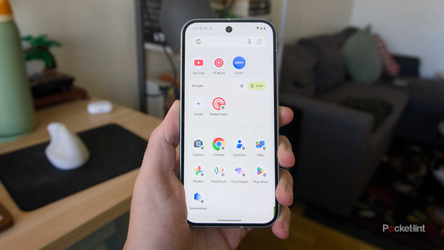 A hand holding a Pixel 9 showing off an unlocked Private Space.