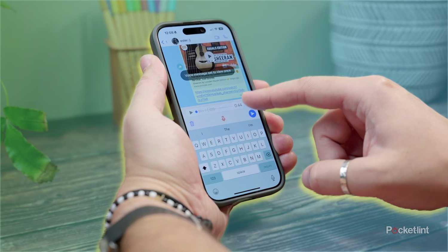 Someone using the WhatsApp app on a colored background