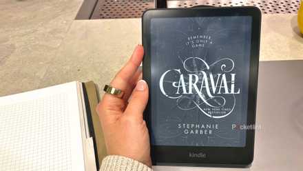A woman holding a Kindle Paperwhite 2024.
