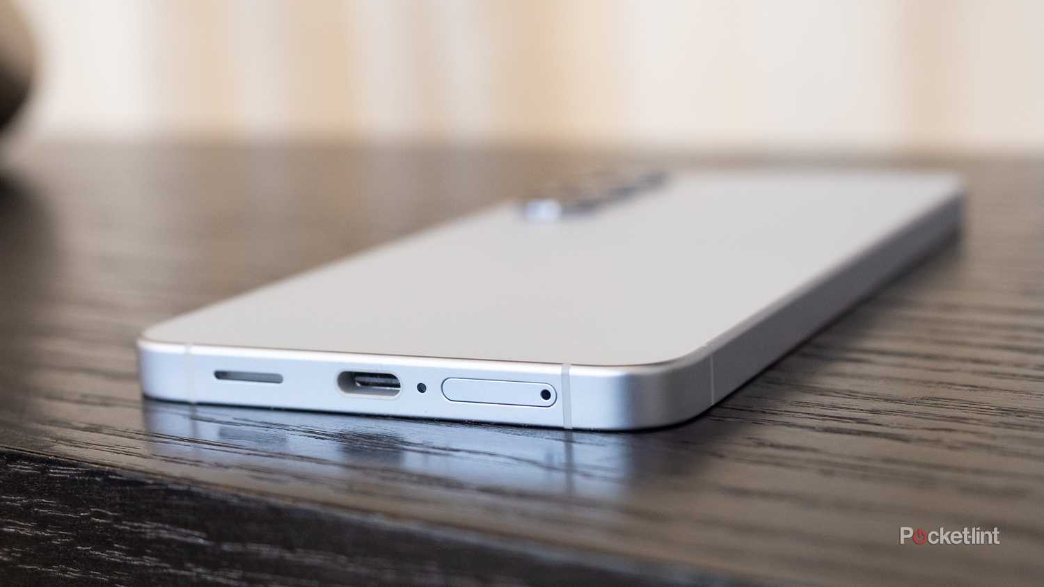 Galaxy S25 USB-C port on a wooden surface. 