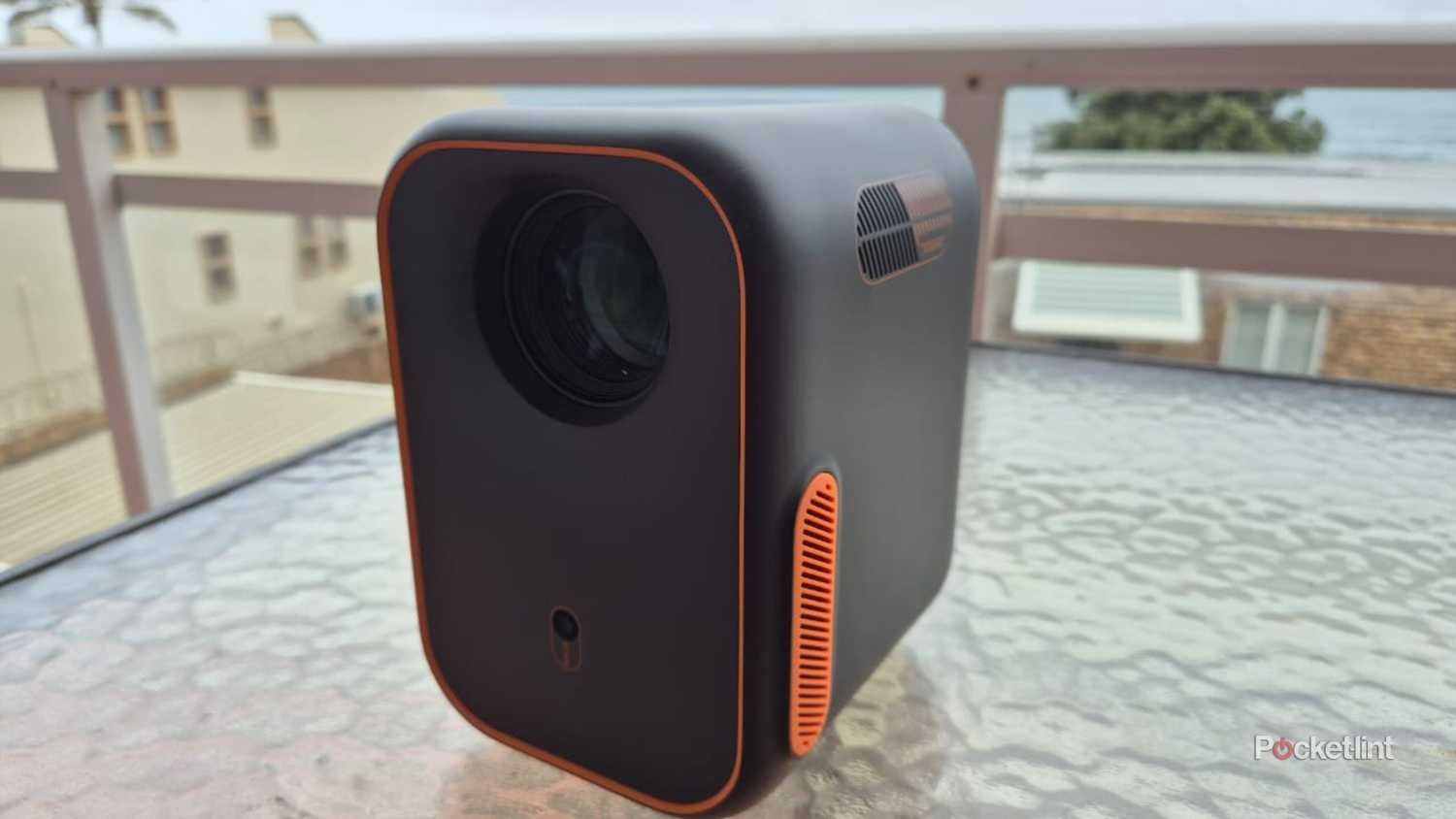 Xming outdoor projector sitting on a glass table. 