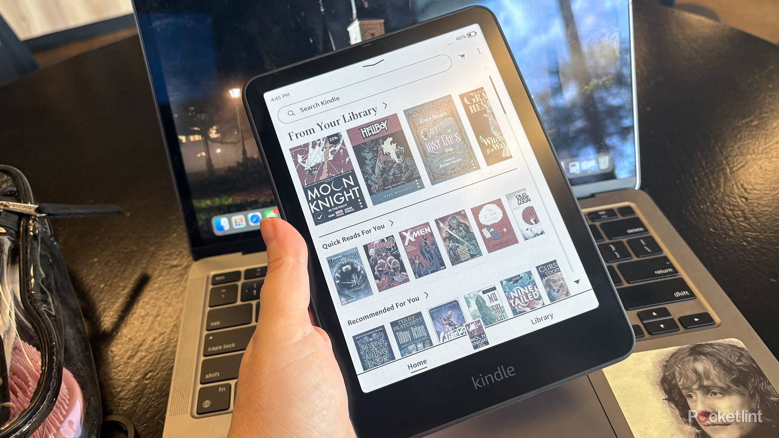 A Kindle Colorsoft in front of a laptop. 