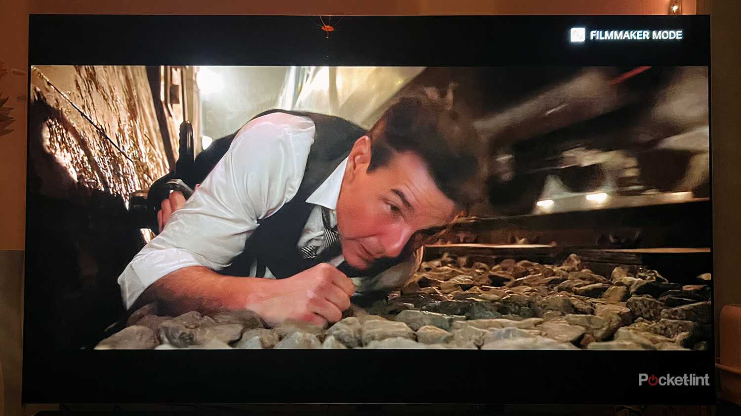 Tom Cruise laying beside a moving train. 