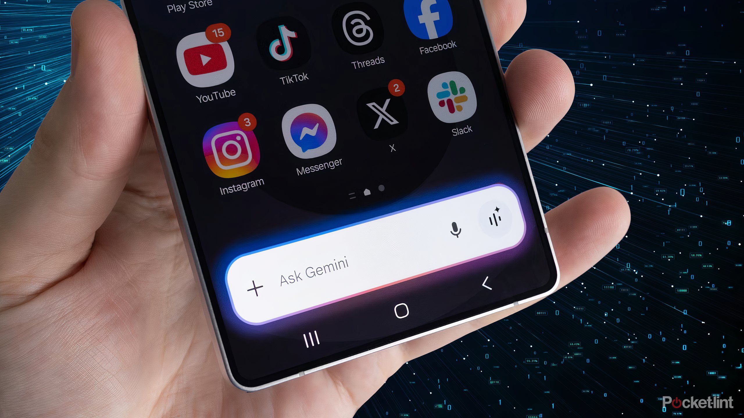 A hand holding a Galaxy S25 Ultra with Gemini open over a dark background.