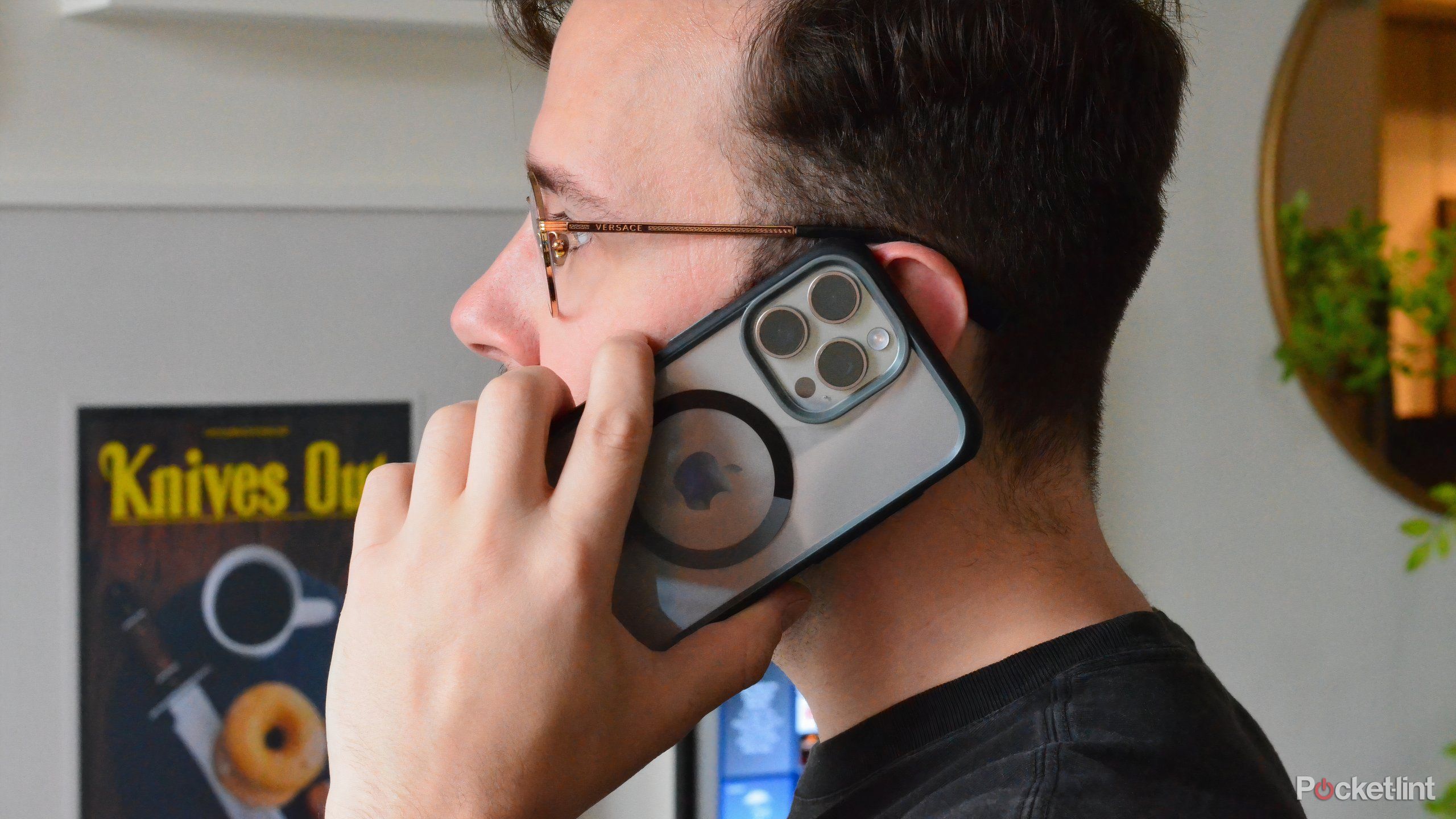 A person holding a phone to his ear. 