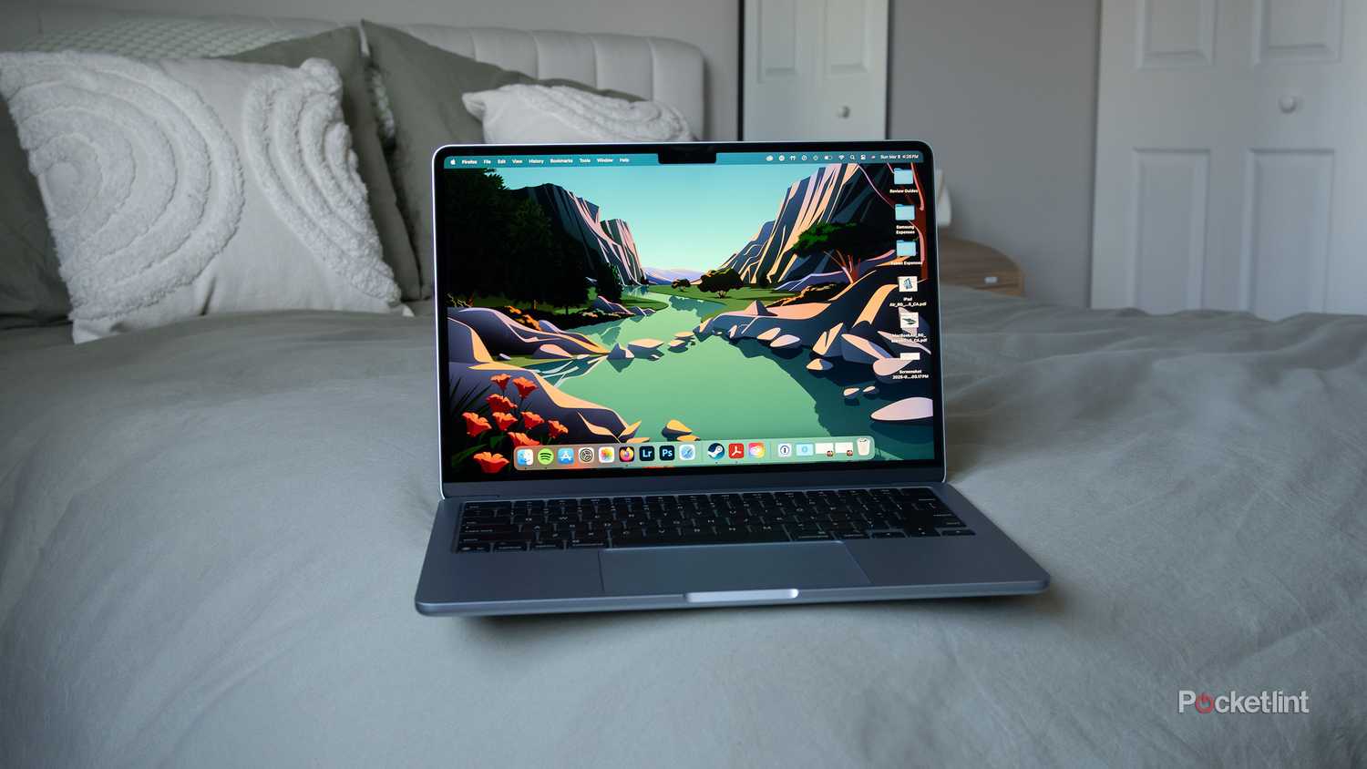 An M4 MacBook Air sitting on a bed.