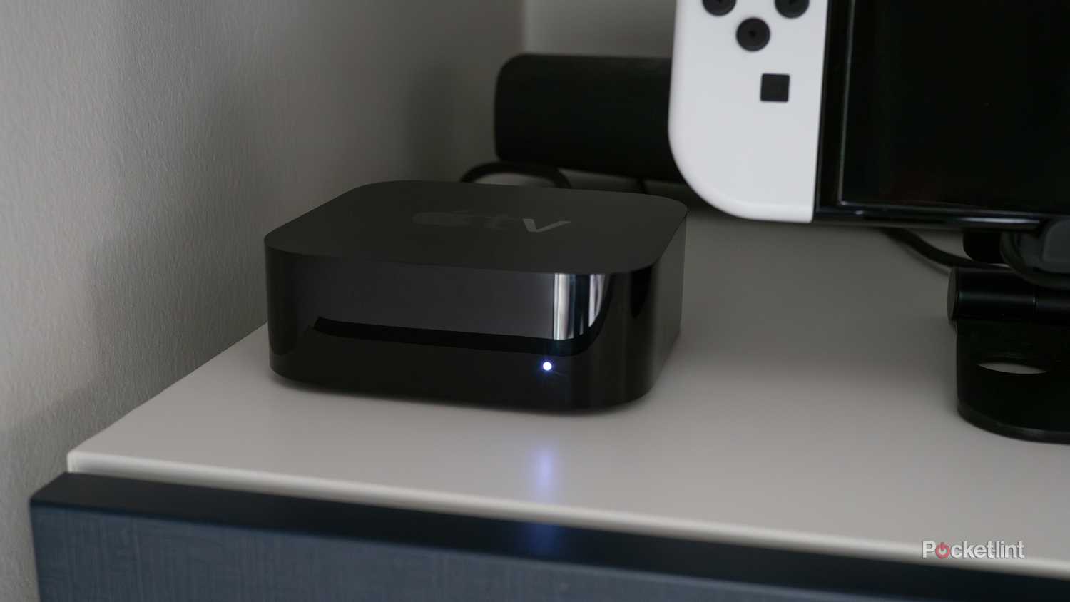 An Apple TV 4K next to a Nintendo Switch OLED.
