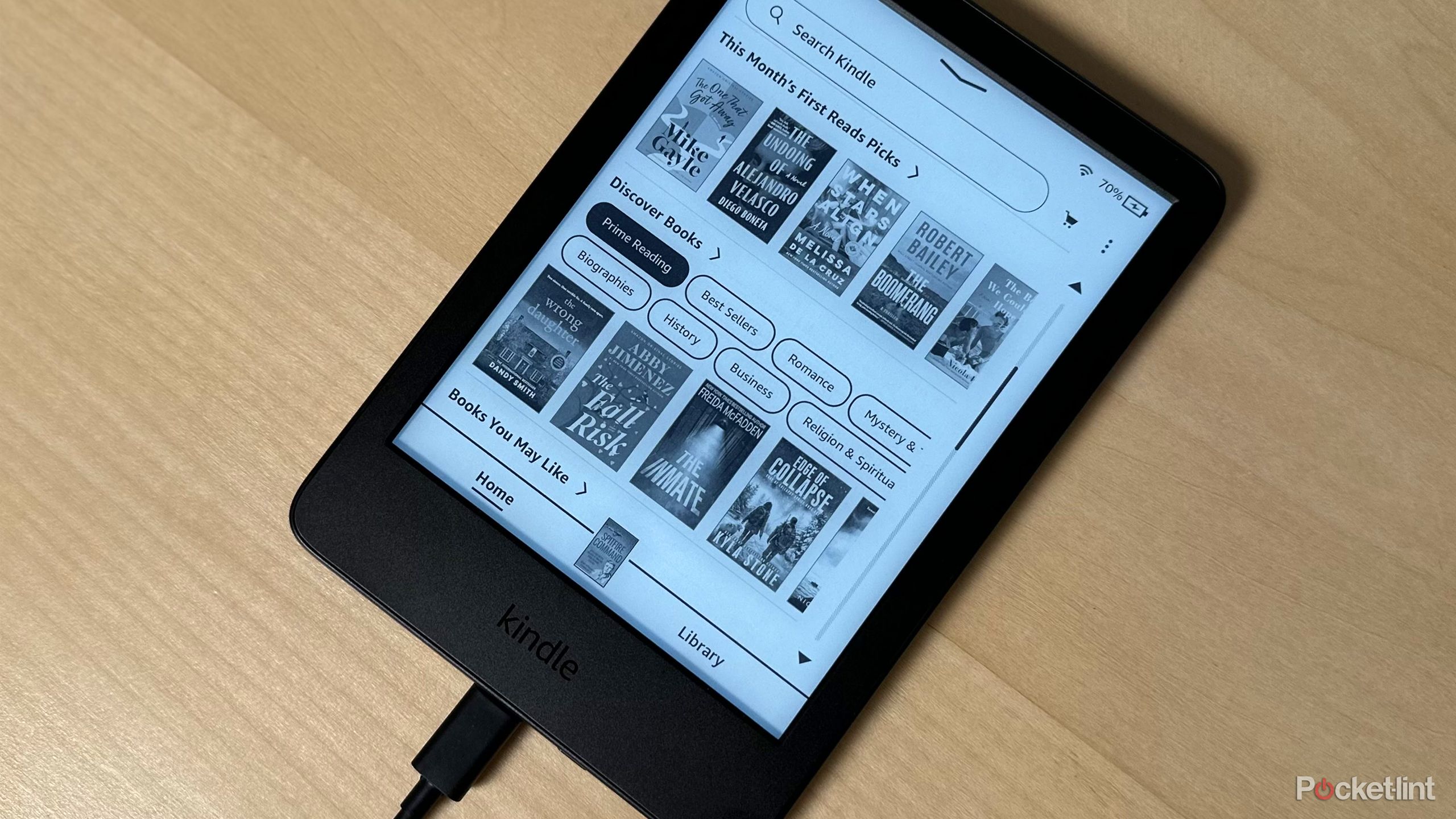 Kindle charging on desk.