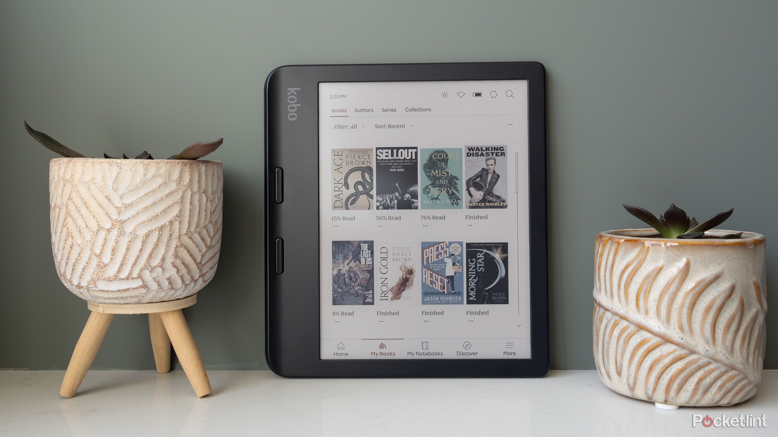 The Kobo Libra Colour sitting beside two plants