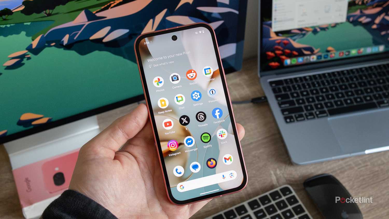 The Pixel 9a being held 