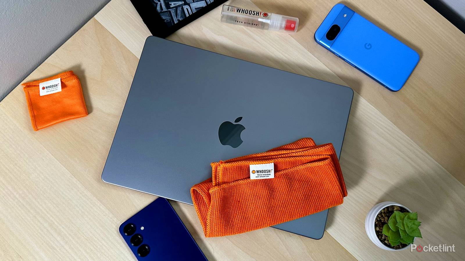 Whoosh cleaning cloth with MacBook and phones.