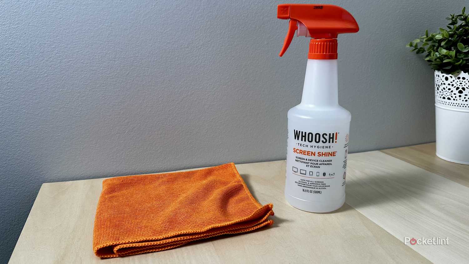 A Whoosh cloth and spray bottle on a desk.