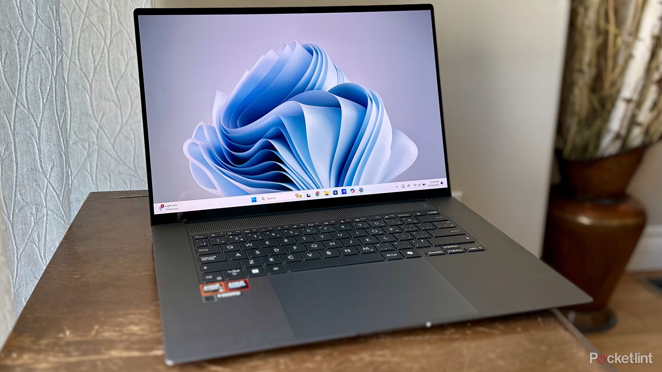 Asus Windows 11 laptop on wood bench.