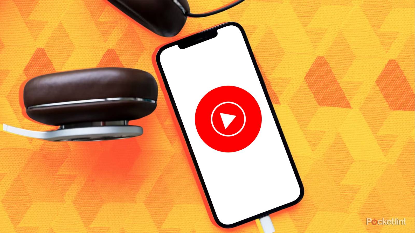 YouTube Music on iPhone next to headphones on orange background.