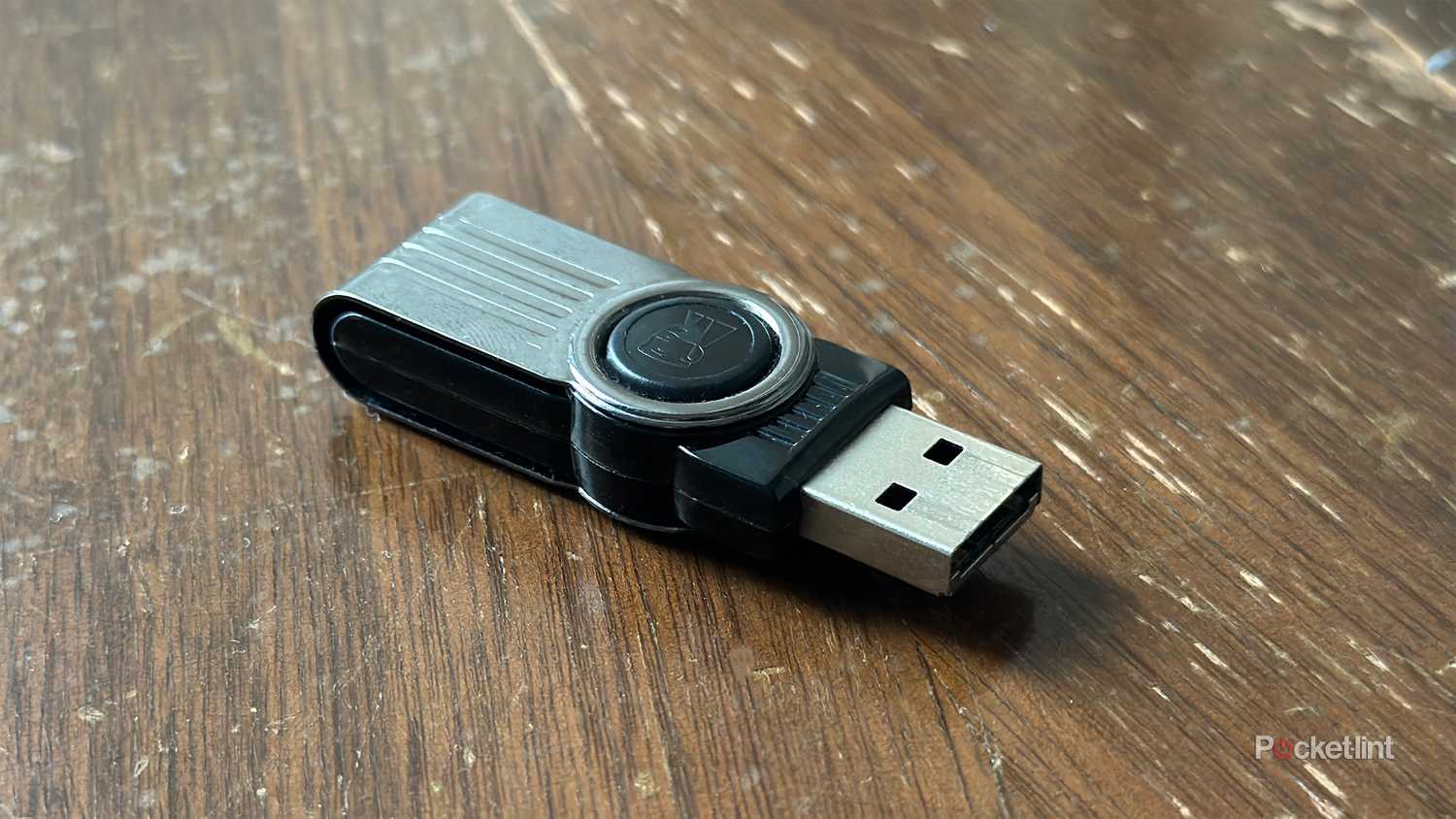 A USB stick on an old wooden storage box.