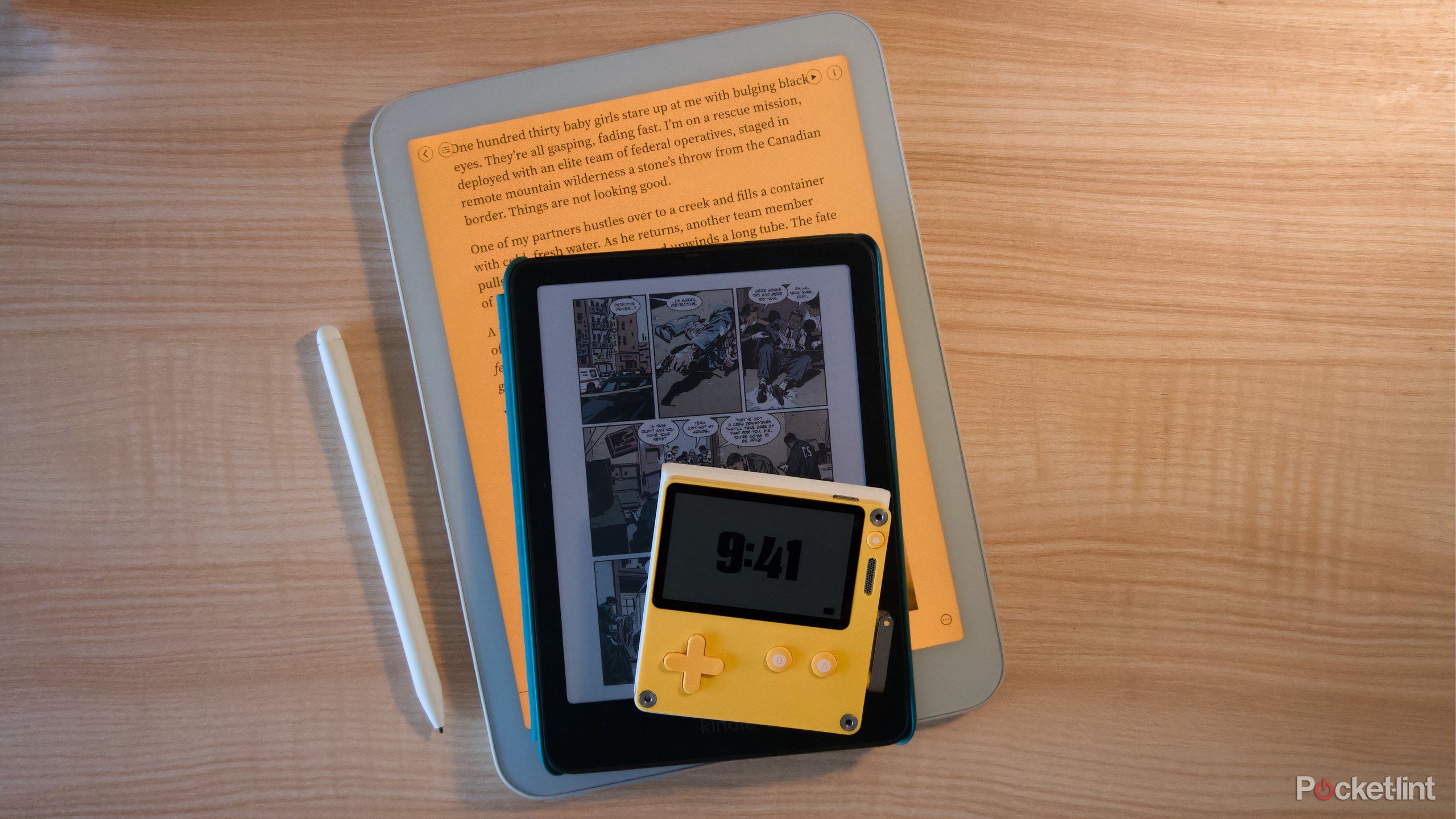 A Daylight DC-1, Kindle Colorsoft, and Panic Playdate sitting on each other with their screens on.