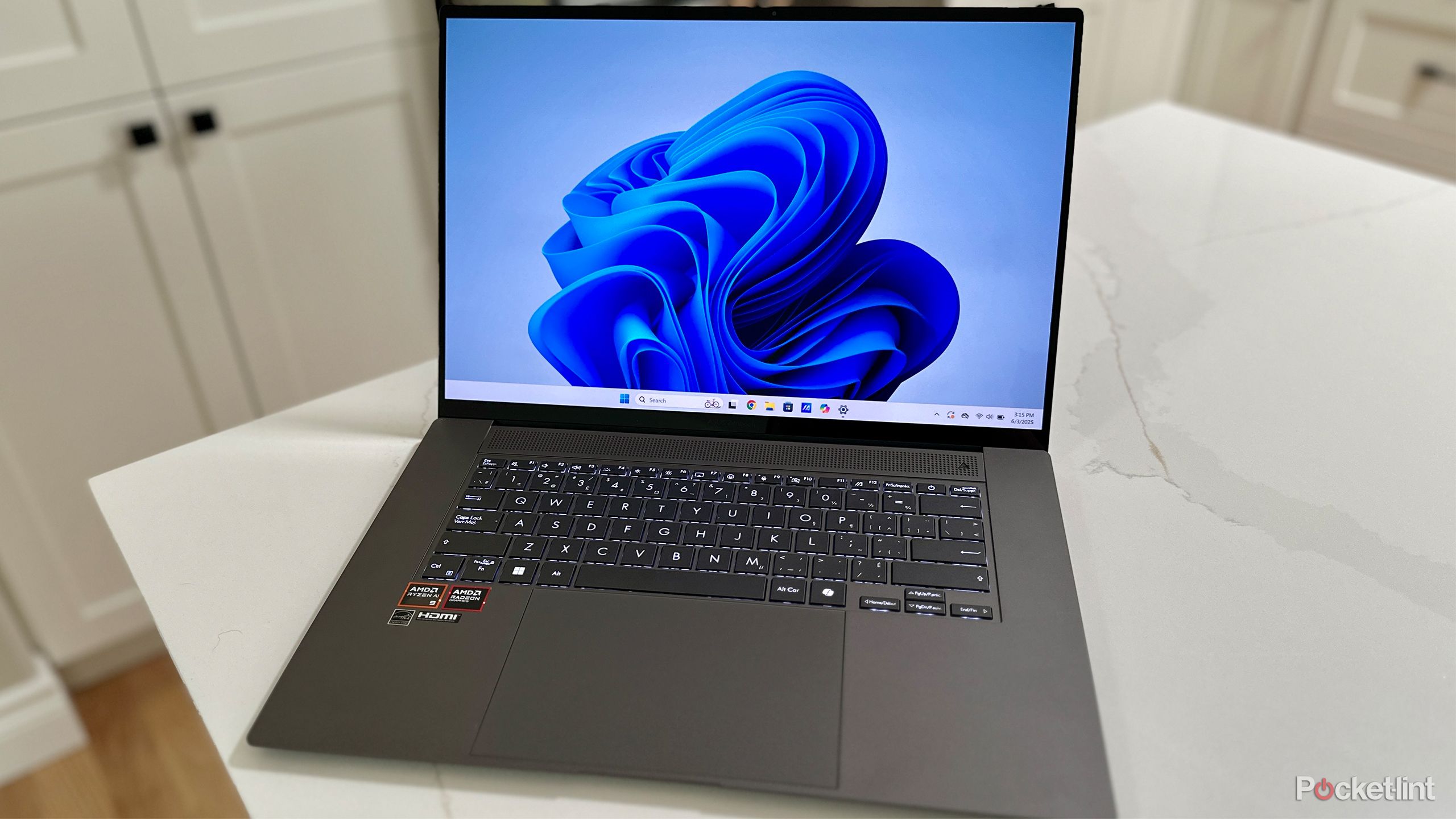 Asus Zenbook 16 on kitchen counter.