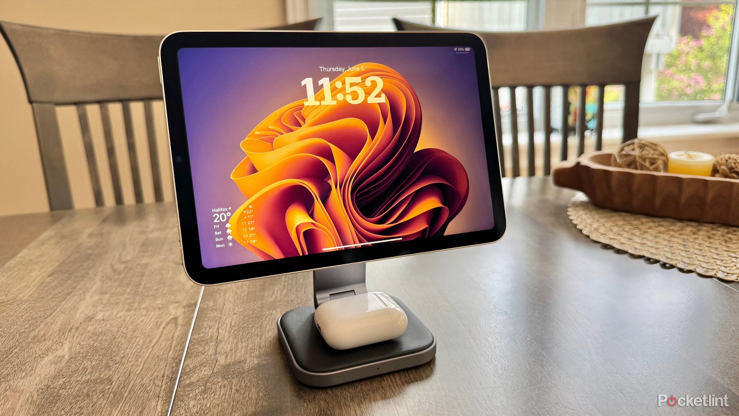 An iPad mini and AirPods on a MagSafe stand.