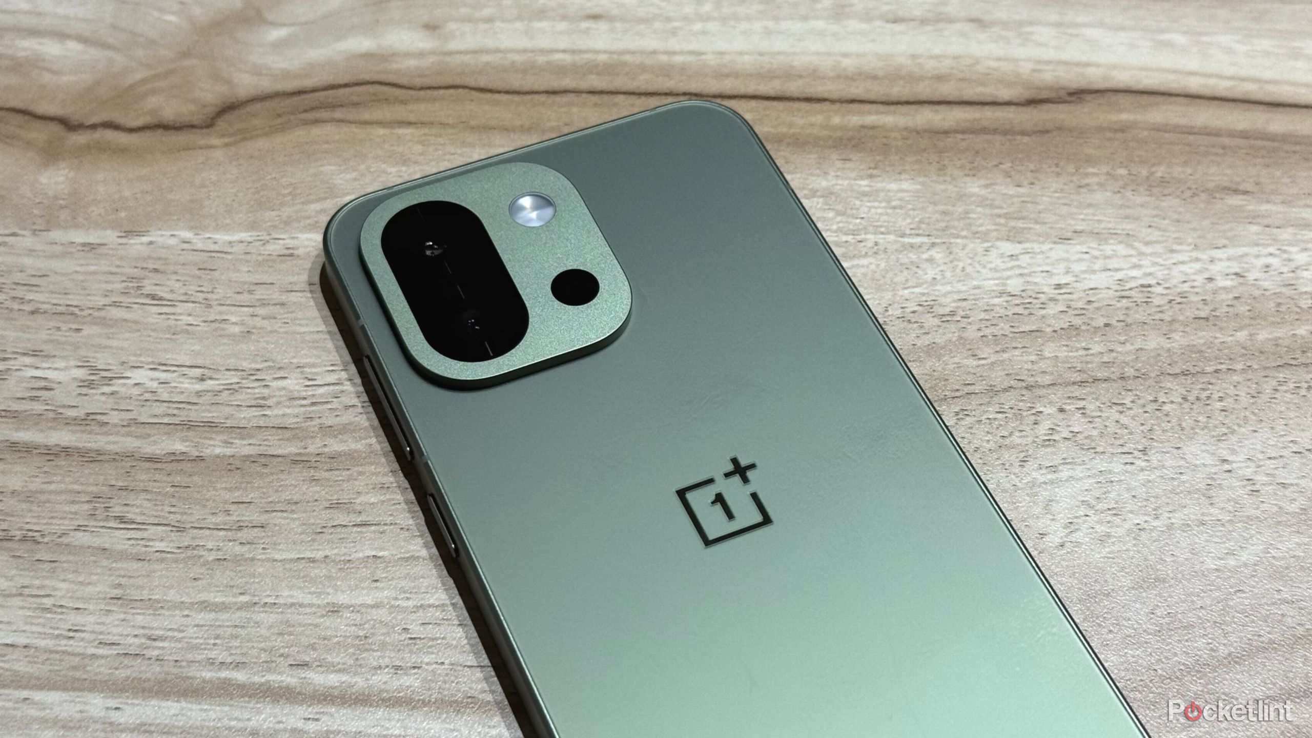 OnePlus 13s on a wooden table