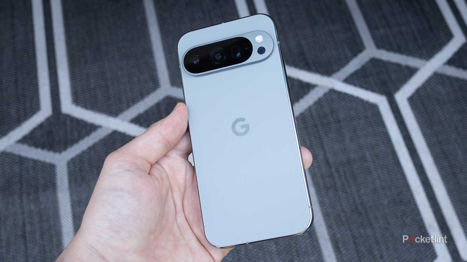 The Pixel 9 Pro held in a hand