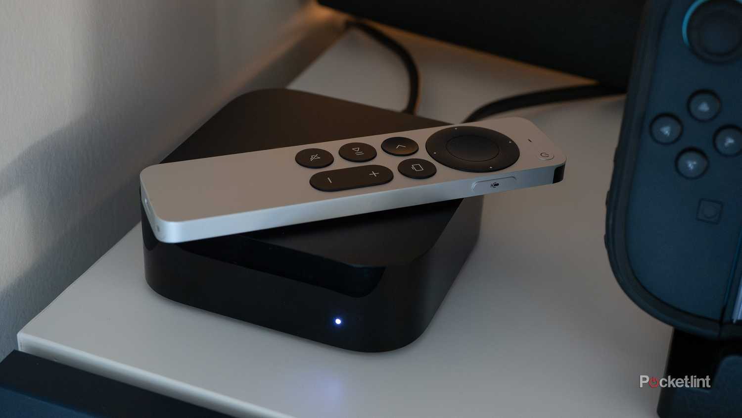Apple TV 4K sitting on a TV shelf