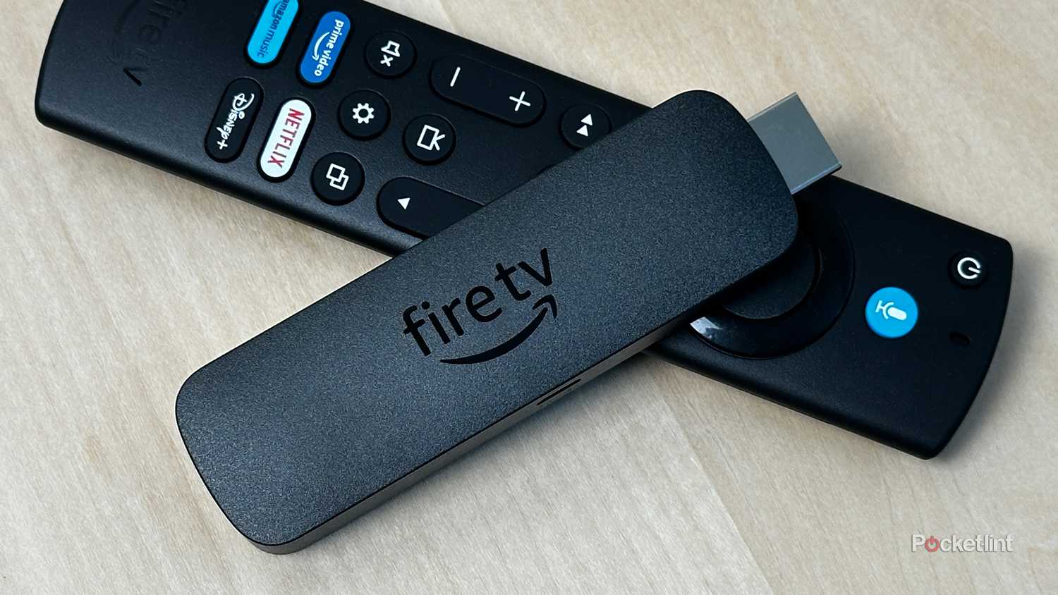 Amazon Fire TV Stick on top of remote.