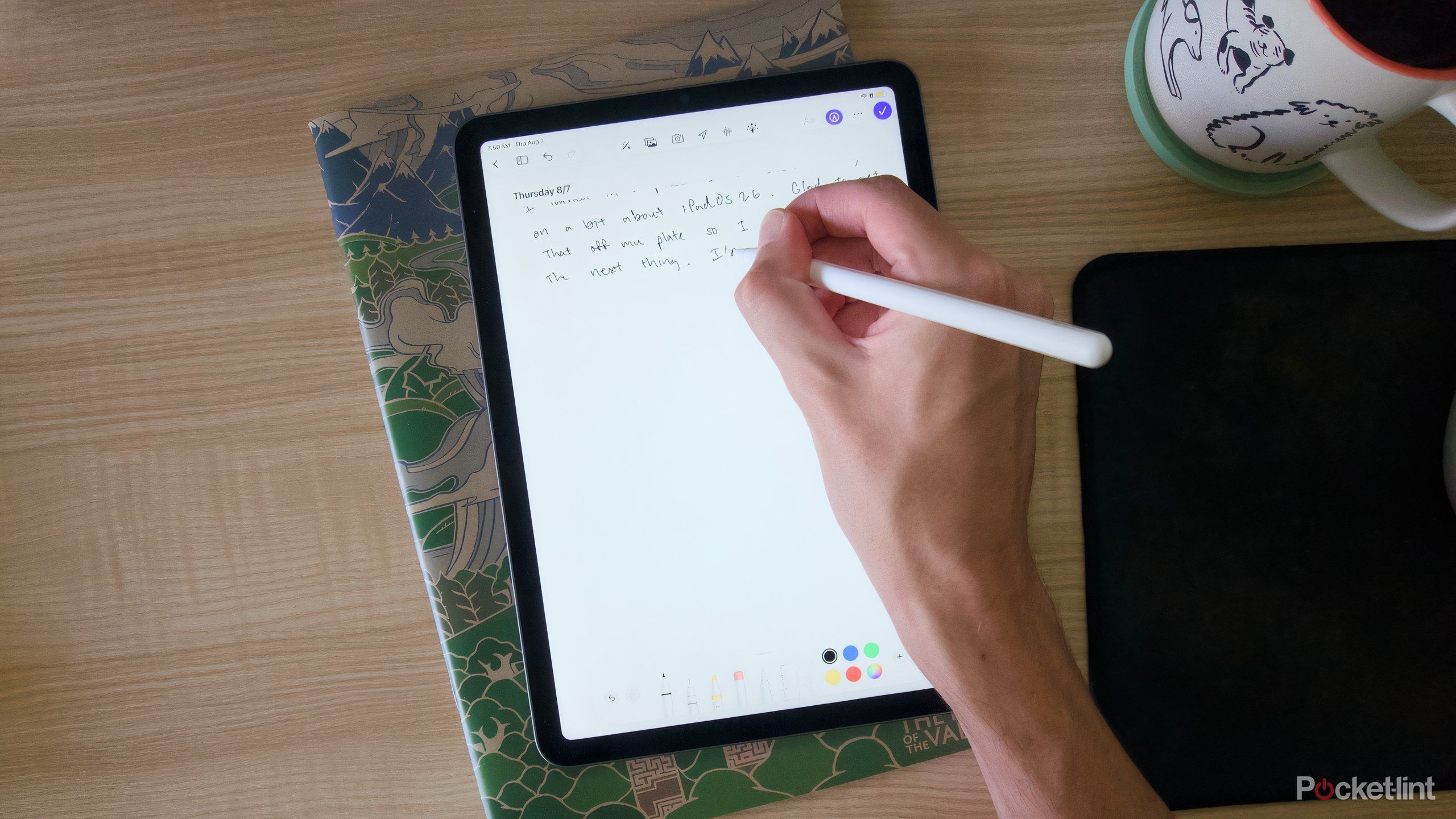 A hand writing in the Journal app on an M1 iPad Air.