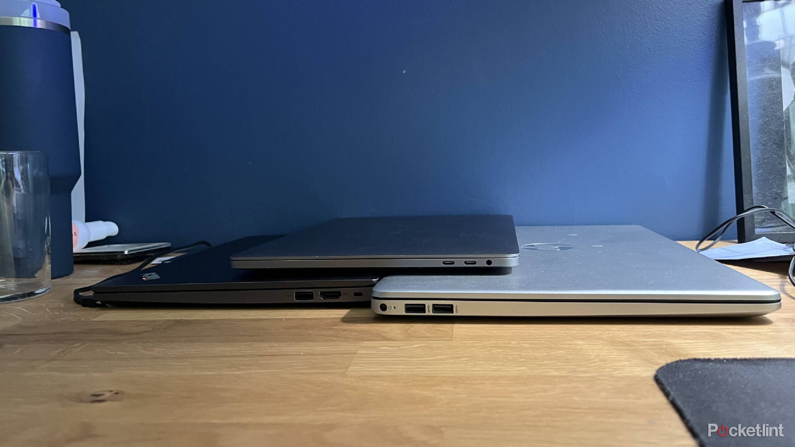 Lenovo, MacBook, and HP laptops showing their USB ports.